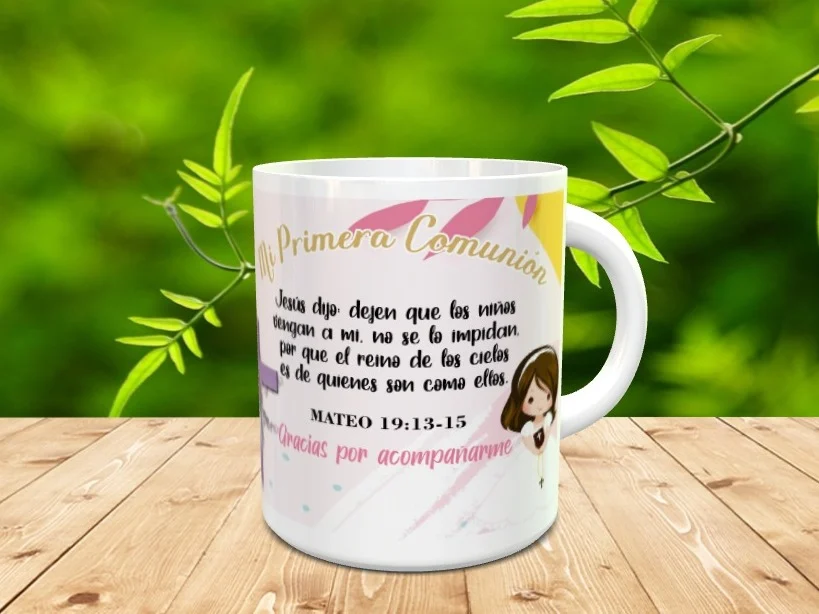 Taza de cerámica blanca para Primera Comunión con ilustración de niña y texto bíblico, apoyada sobre superficie de madera.